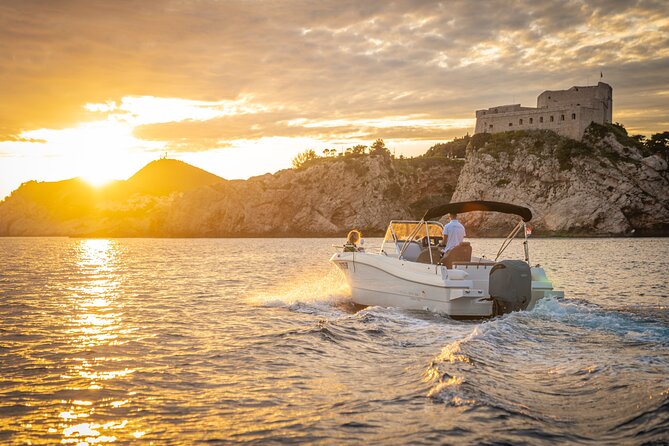 Dubrovnik Sunset Tour By Boat With Local - Dubrovnik’s city walls from the Adriatic: scale hits differently